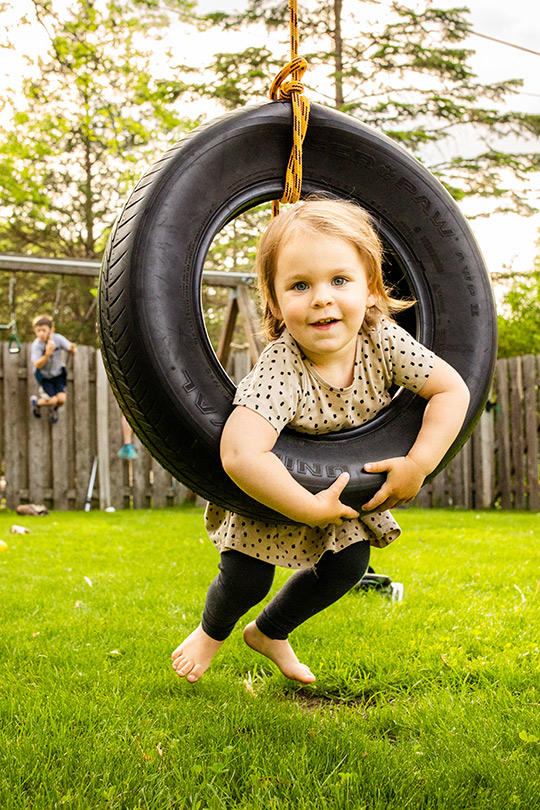 Child on tire swing