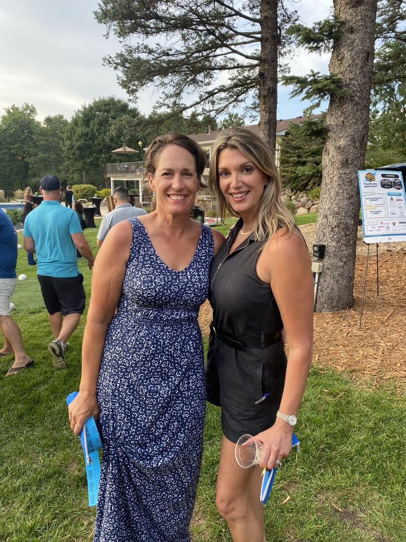 Jenny Peterson with a friend at an outdoor community fundraiser